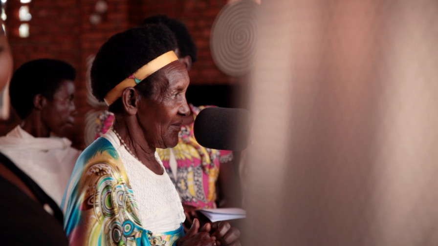 Participant from Rwanda Program, at a microphone. Photo credit: Aidan O'Neill