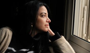 Zeina by the window at home