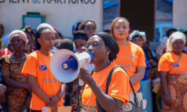 Ida Mukungilwa with microphone
